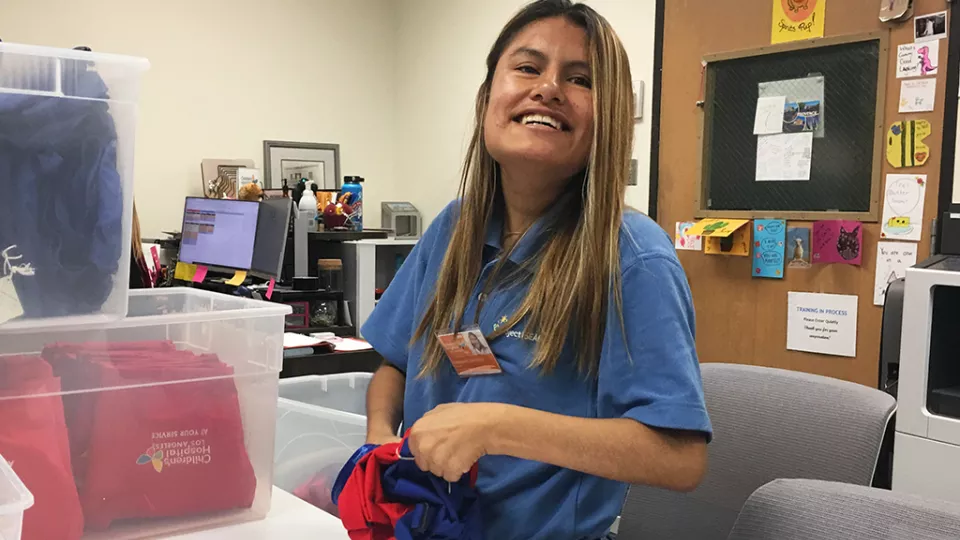 Smiling woman wearing a blue shirt.