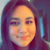 Selfie of a smiling young woman with medium skin tone and dark hair